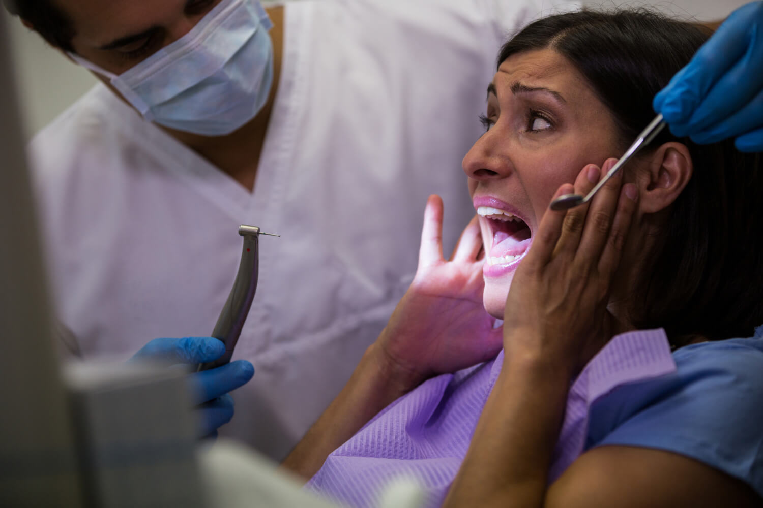 female-patient-scared-during-dental-check-up female-patient-scared-during-dental-check-up